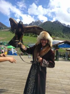 The author holding a falcon, wearing Kazakh robe and fur hat.